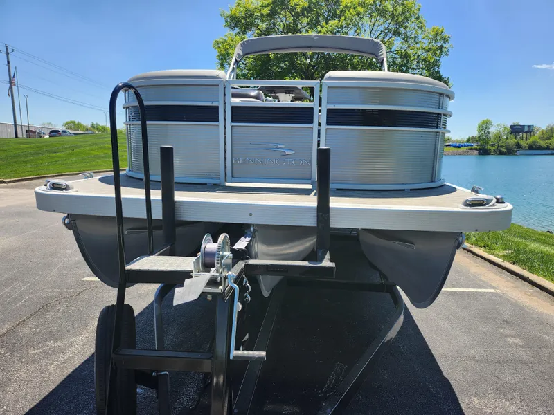 Slide: The Image of 2020 Bennington SX 22 SSRCX pontoon boat on a trailer by a lake. - 6