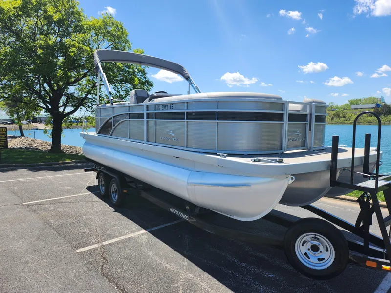 Slide: The Image of 2020 Bennington SX 22 SSRCX pontoon boat on a trailer by a lake. - 8