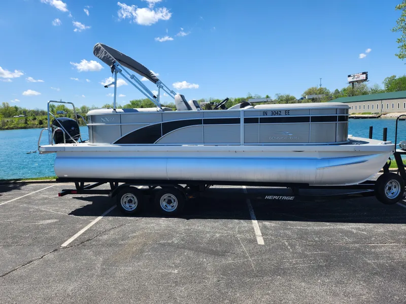 Slide: The Image of 2020 Bennington SX 22 SSRCX pontoon boat on a trailer by a lake. - 9
