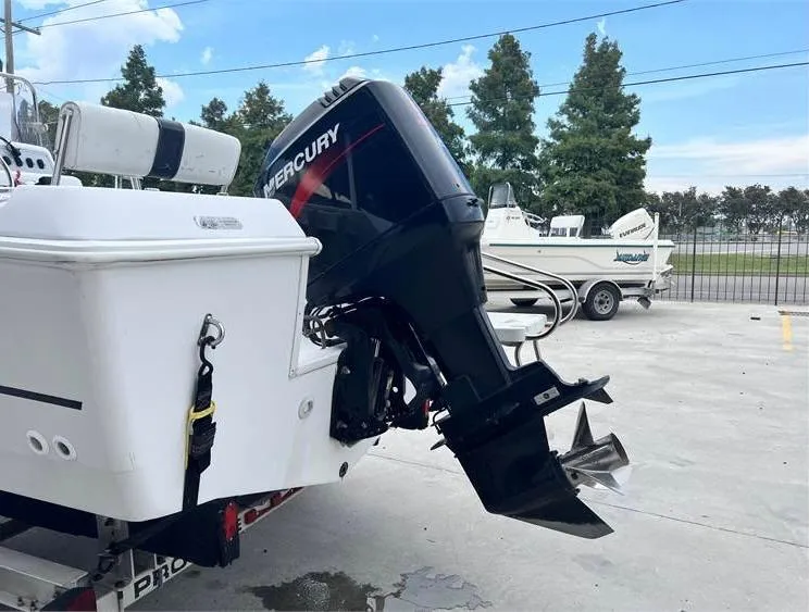 Slide: The Image of 1999 Pro-Line 170CC boat with Mercury outboard motor in a parking lot. - 10