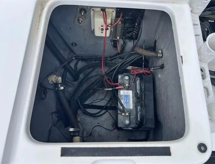 Slide: The Image of Battery compartment of a 1999 Pro-Line 170CC boat with wiring and components. - 13