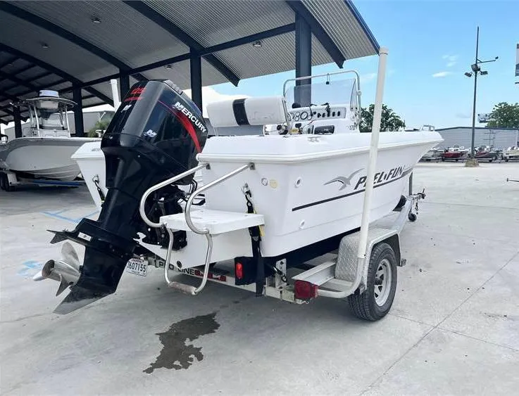 Slide: The Image of 1999 Pro-Line 170CC boat with Mercury outboard motor on a trailer. - 3