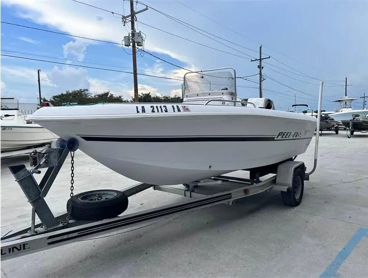 Slide: The Image of 1999 Pro-Line 170CC boat on trailer in marina. - 4