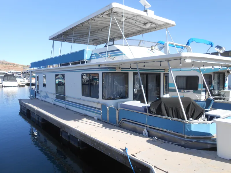 The Image of 2001 Stardust Cruisers houseboat docked at a marina on a sunny day. - 1