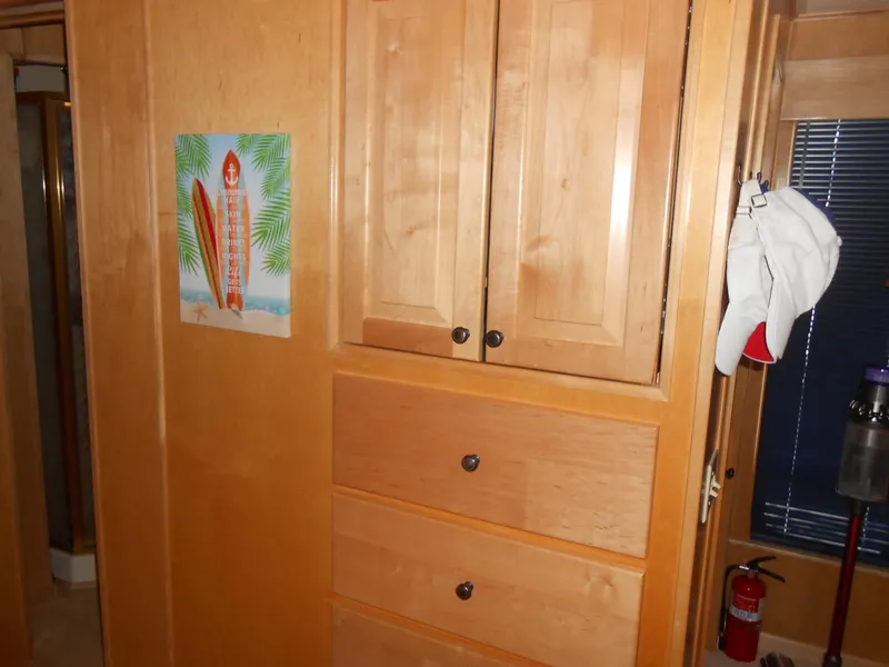Slide: The Image of Wooden cabinets and drawers inside a 2001 Stardust Cruisers houseboat. - 15