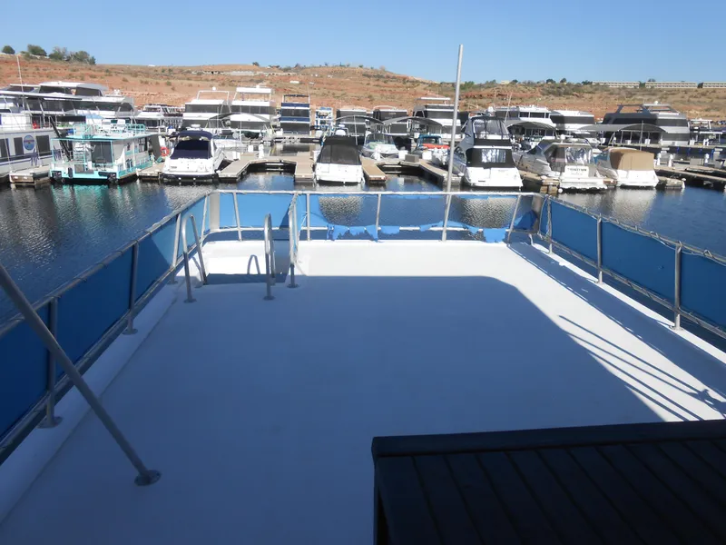 Slide: The Image of Top deck of a 2001 Stardust Cruisers houseboat docked at a marina. - 22