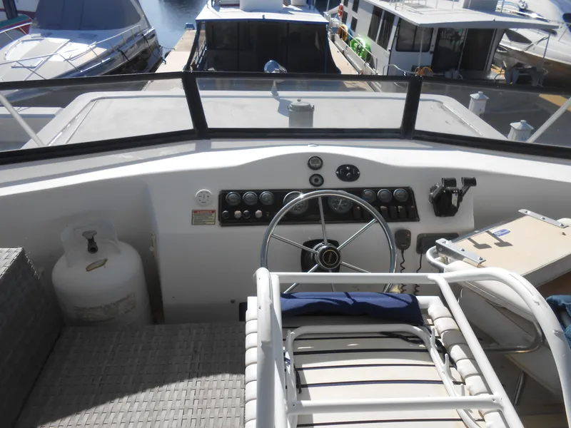 Slide: The Image of 2001 Stardust Cruisers Houseboat helm with steering wheel and control panel. - 23