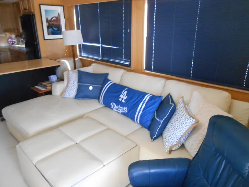 Slide: The Image of Interior of 2001 Stardust Cruisers houseboat with cozy seating area and Dodgers-themed pillows. - 3