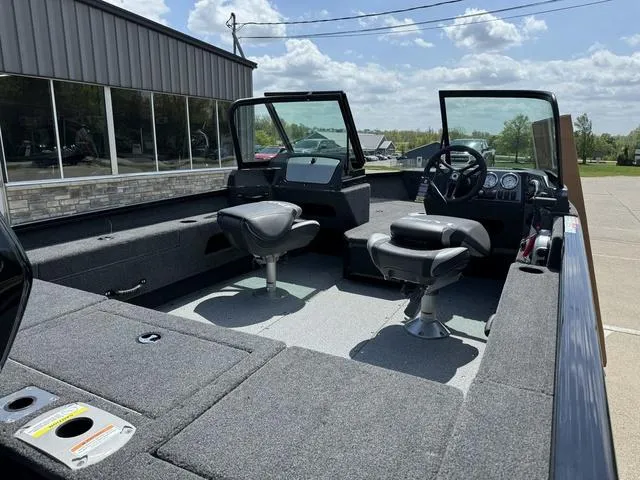 Slide: The Image of 2024 Lund 1775 Adventure Sport boat interior with two swivel seats and console. - 3