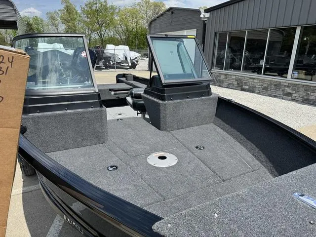 Slide: The Image of 2024 Lund 1775 Adventure Sport boat with open deck and windshield. - 7