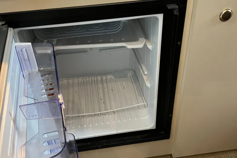 Slide: The Image of Open refrigerator inside a 2000 Cruisers Yachts 3075 Express. - 17