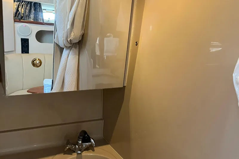 Slide: The Image of Bathroom interior of a 2000 Cruisers Yachts 3075 Express with sink and mirror. - 25