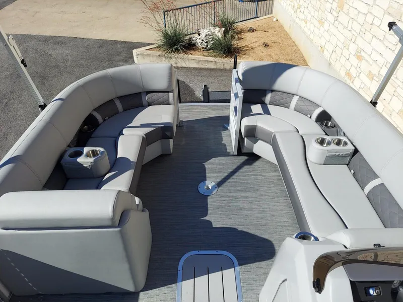 Slide: The Image of 2023 Bennington 23L pontoon boat interior with gray seating and cup holders. - 4