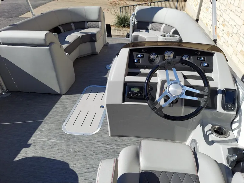 Slide: The Image of 2023 Bennington 23L boat interior with steering wheel and seating area. - 6