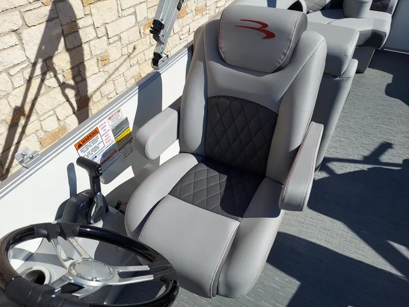 Slide: The Image of Captain's chair and steering wheel of 2023 Bennington 23L boat, featuring sleek design and controls. - 7