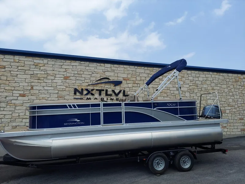 Slide: The Image of 2023 Bennington 22S pontoon boat on trailer at NXT LVL Marine dealership. - 1