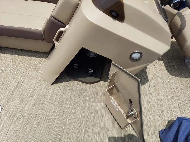 Slide: The Image of 2023 Bennington 22S boat interior with open storage compartment and seating. - 10