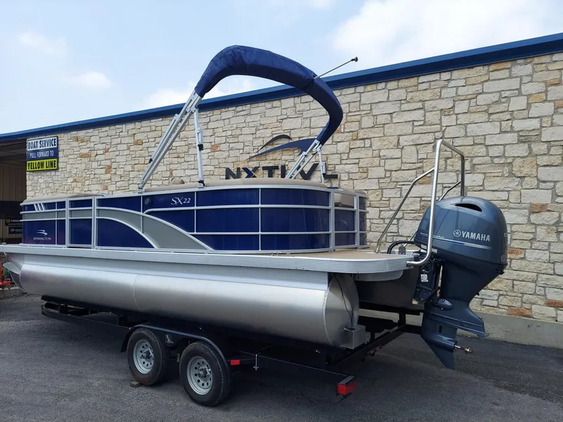 Slide: The Image of 2023 Bennington 22S pontoon boat with Yamaha motor on trailer. - 2