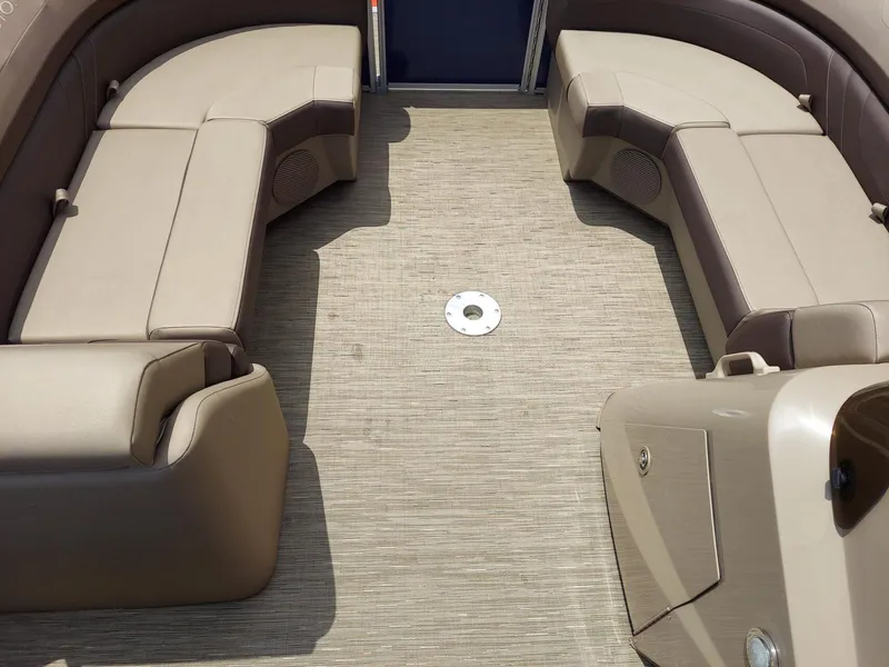 Slide: The Image of 2023 Bennington 22S boat interior with beige seating and carpeted floor. - 4