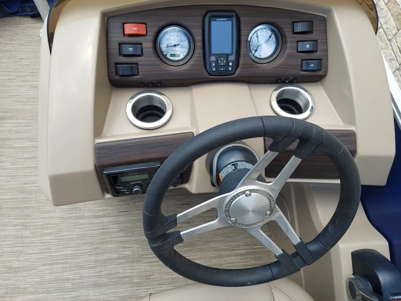 Slide: The Image of 2023 Bennington 22S boat dashboard with steering wheel, gauges, and controls. - 5