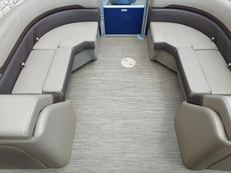 Slide: The Image of 2023 Bennington 22S boat interior with beige and brown seating, spacious layout. - 6