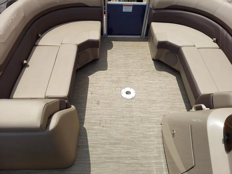 Slide: The Image of 2023 Bennington 22S pontoon boat interior with beige seating and spacious deck. - 9