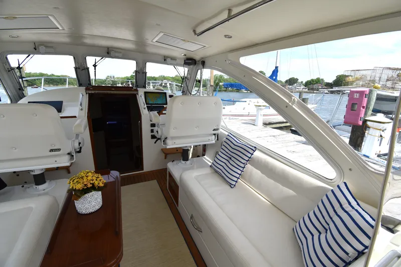 Slide: The Image of Interior of 2011 MJM 40z Downeast yacht with white seating and striped cushions. - 14