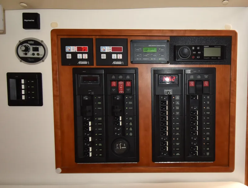 Slide: The Image of Control panel of a 2011 MJM 40z Downeast boat with various switches and gauges. - 28