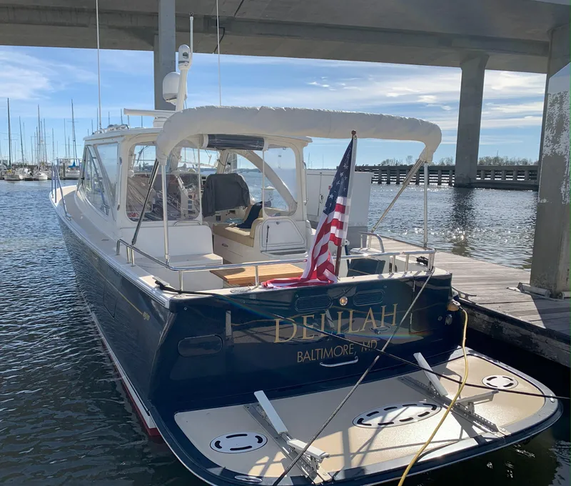 Slide: The Image of 2011 MJM 40z Downeast boat docked, rear view with American flag, named Delilah from Baltimore, MD. - 3