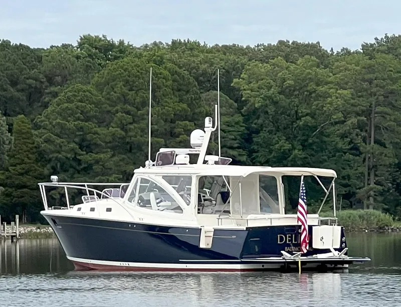 Slide: The Image of 2011 MJM 40z Downeast boat on a calm lake with forested background. - 33