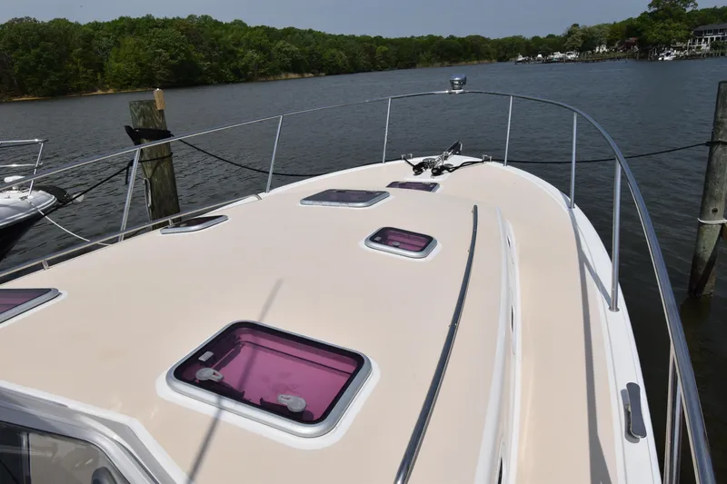 Slide: The Image of 2011 MJM 40z Downeast boat deck with hatches, docked on a calm river. - 6