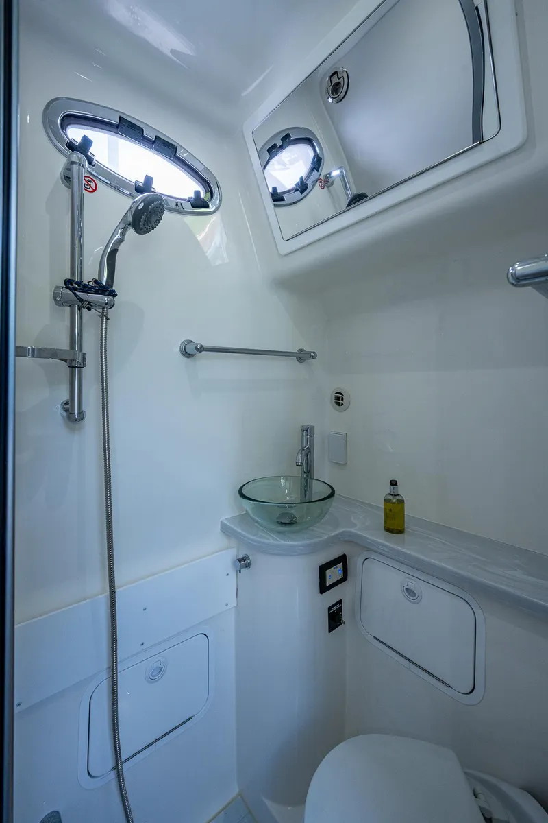 Slide: The Image of 2022 Regulator 41 boat bathroom with modern fixtures and porthole windows. - 41