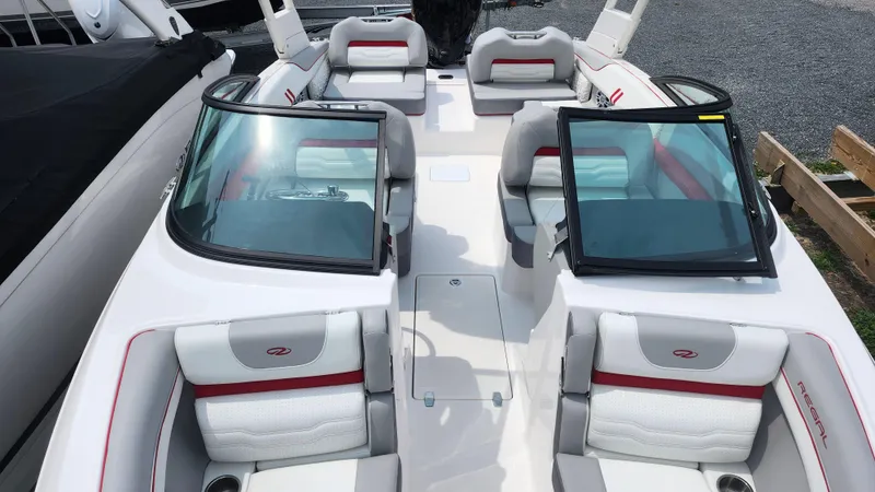Slide: The Image of 2025 Regal LX2 boat interior with open storage compartment and seating. - 10
