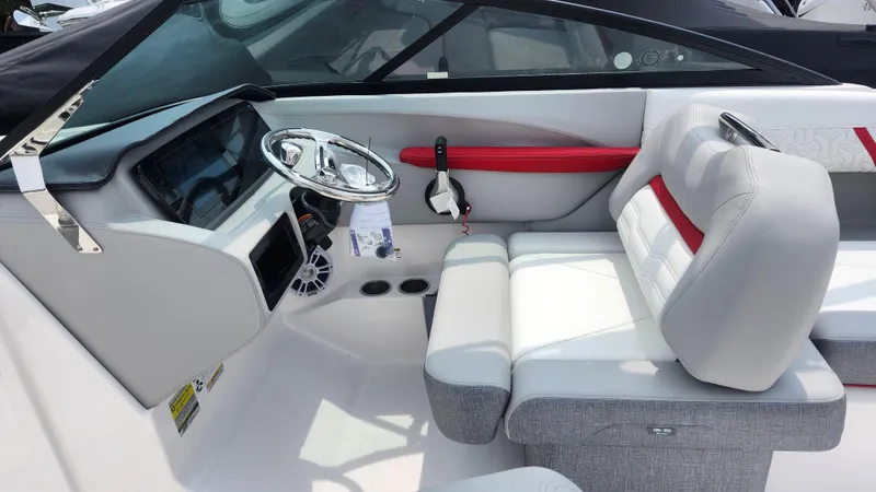 Slide: The Image of 2025 Regal LX2 boat interior with modern steering and seating. - 14