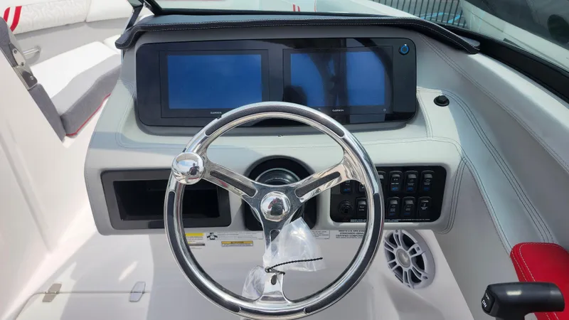 Slide: The Image of Steering wheel and dashboard of 2025 Regal LX2 boat with dual screens. - 15