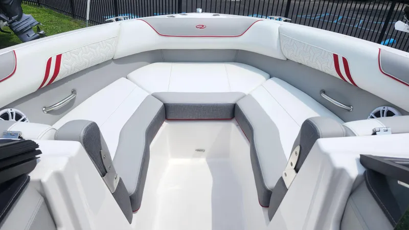 Slide: The Image of 2025 Regal LX2 boat interior with white and gray seating, red accents, and modern design. - 8