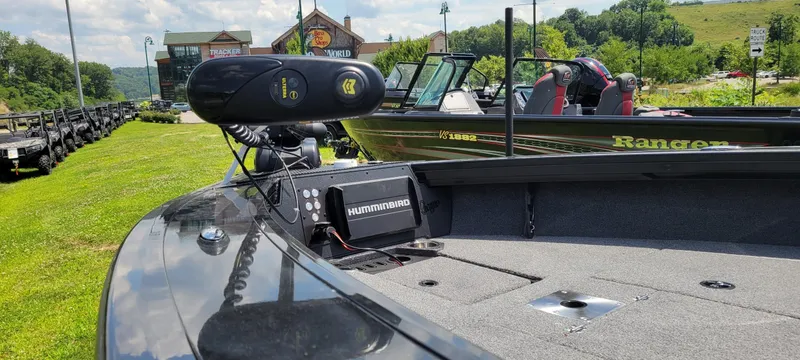 Slide: The Image of 2024 Ranger VX1988 WT boat with Humminbird electronics, parked outdoors near a store. - 4