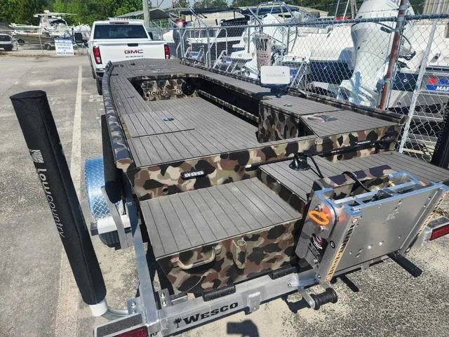 Slide: The Image of 2024 Low Country Swamp Fox 19 PRO boat in camouflage on a Wesco trailer. - 3