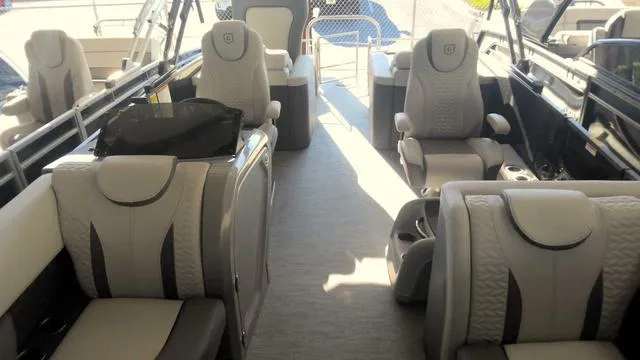 Slide: The Image of 2024 MONACO Monaco 235 RL boat interior with luxurious seating. - 1
