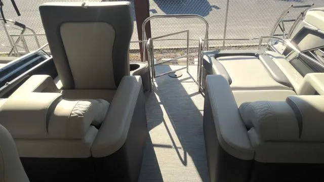 Slide: The Image of 2024 MONACO Monaco 235 RL boat interior with plush seating and sun deck. - 2