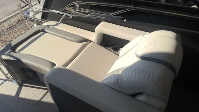 Slide: The Image of Luxurious seating on the 2024 MONACO Monaco 235 RL boat, featuring cup holders and premium upholstery. - 3
