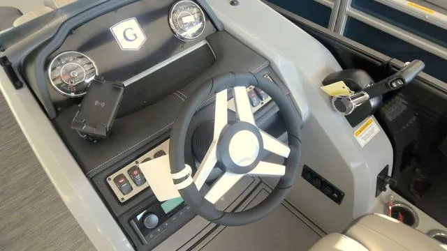 Slide: The Image of 2024 MONACO Monaco 235 RL boat dashboard with steering wheel and control panel. - 5