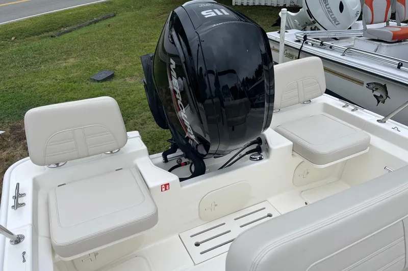 Slide: The Image of 2026 Boston Whaler 170 Montauk boat with Mercury outboard motor, white seating. - 11