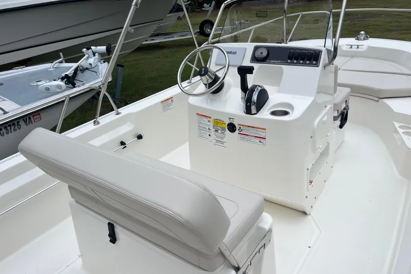 Slide: The Image of 2026 Boston Whaler 170 Montauk boat interior with steering console and seating. - 13