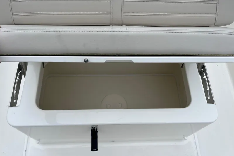 Slide: The Image of 2026 Boston Whaler 170 Montauk boat storage compartment with cushioned seat. - 15
