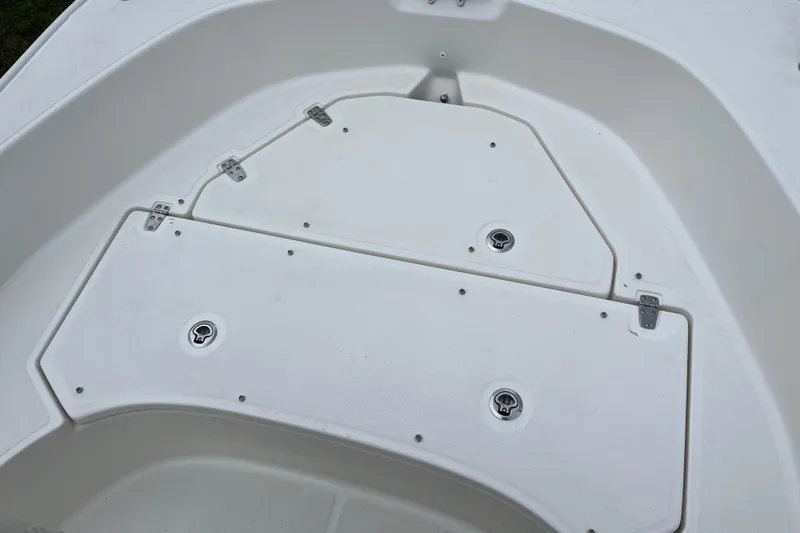 Slide: The Image of 2026 Boston Whaler 170 Montauk boat deck with storage compartments and hinges. - 18