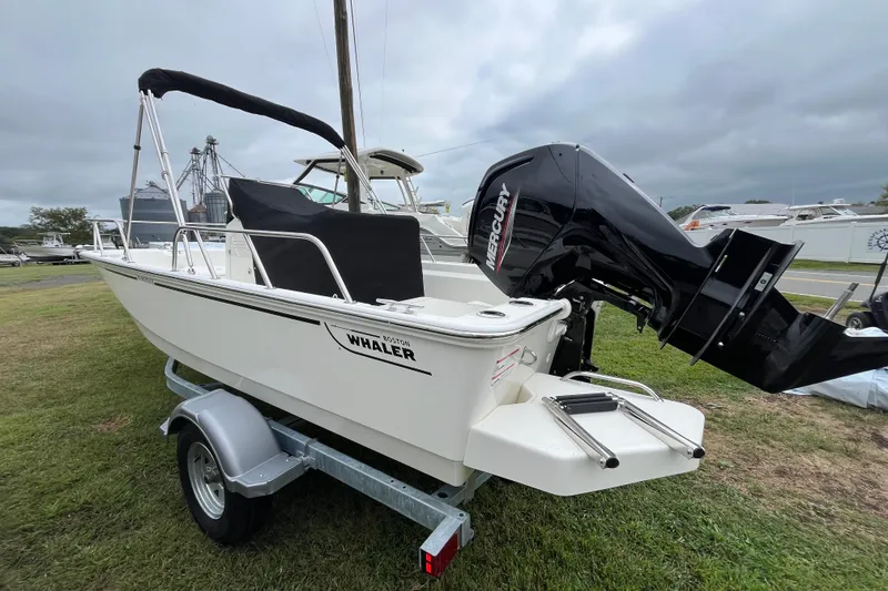 Slide: The Image of 2026 Boston Whaler 170 Montauk boat on trailer with Mercury outboard engine. - 25