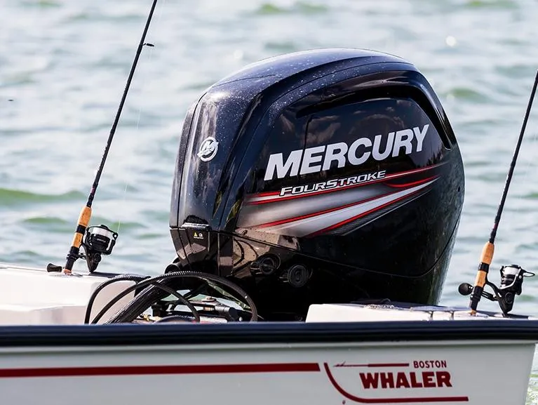 Slide: The Image of 2026 Boston Whaler 170 Montauk boat with Mercury 115 engine, docked on grass. - 3