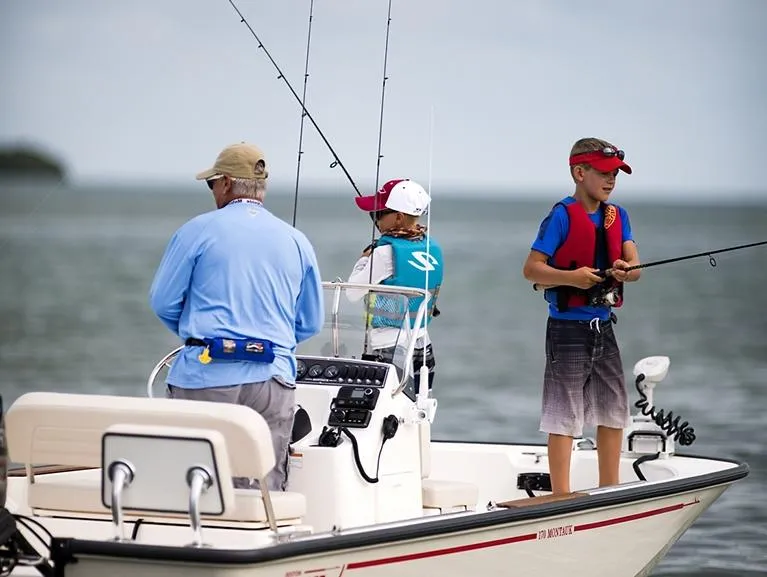 Slide: The Image of 2026 Boston Whaler 170 Montauk boat console with steering wheel and controls. - 5