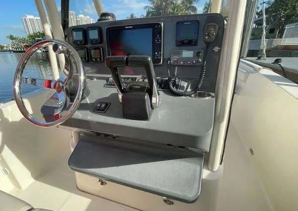 Slide: The Image of 2013 Pursuit C 260 Center Console boat helm with steering wheel and navigation equipment. - 21